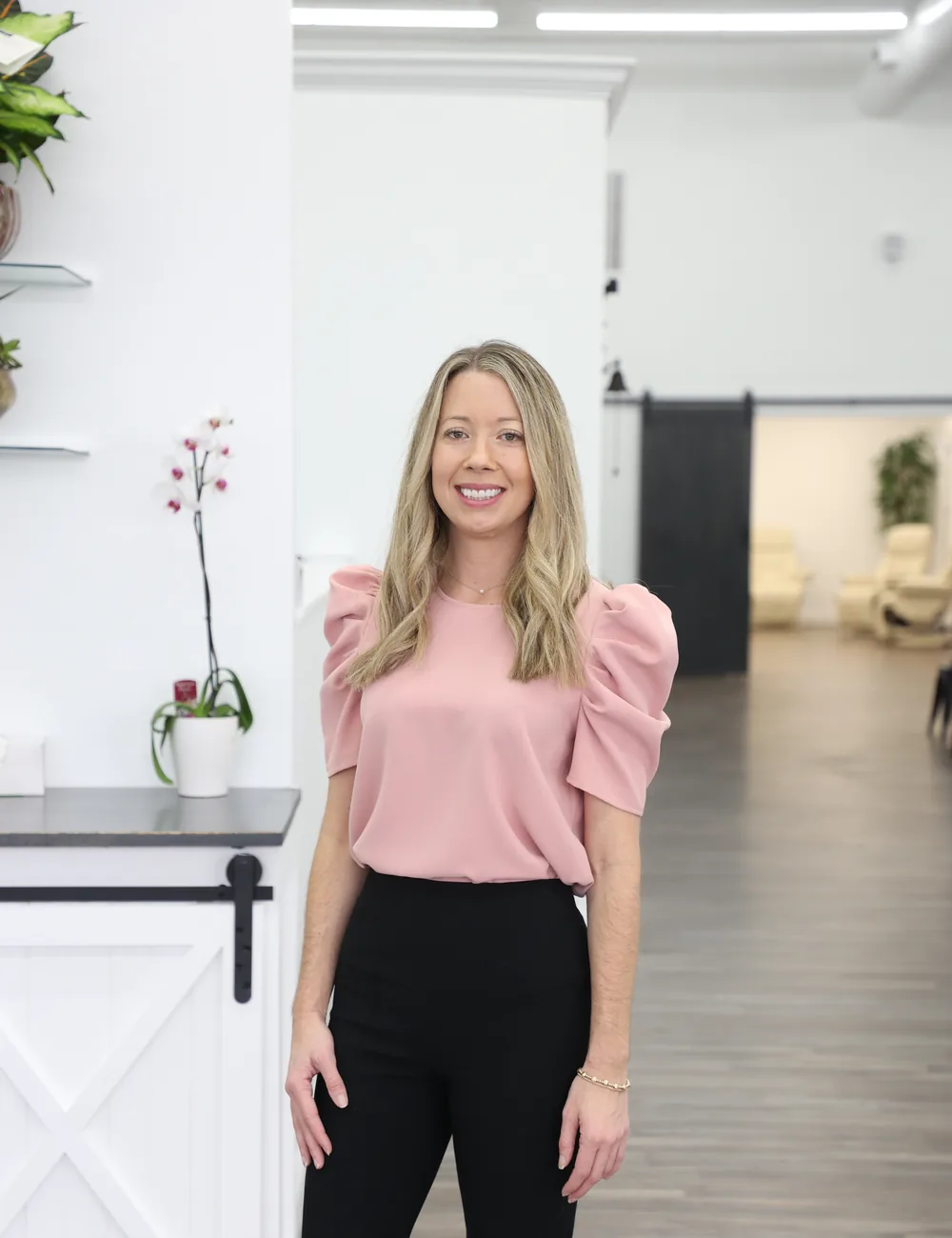 Dr. Candy Ellis standing in the front room of The Reset Studio